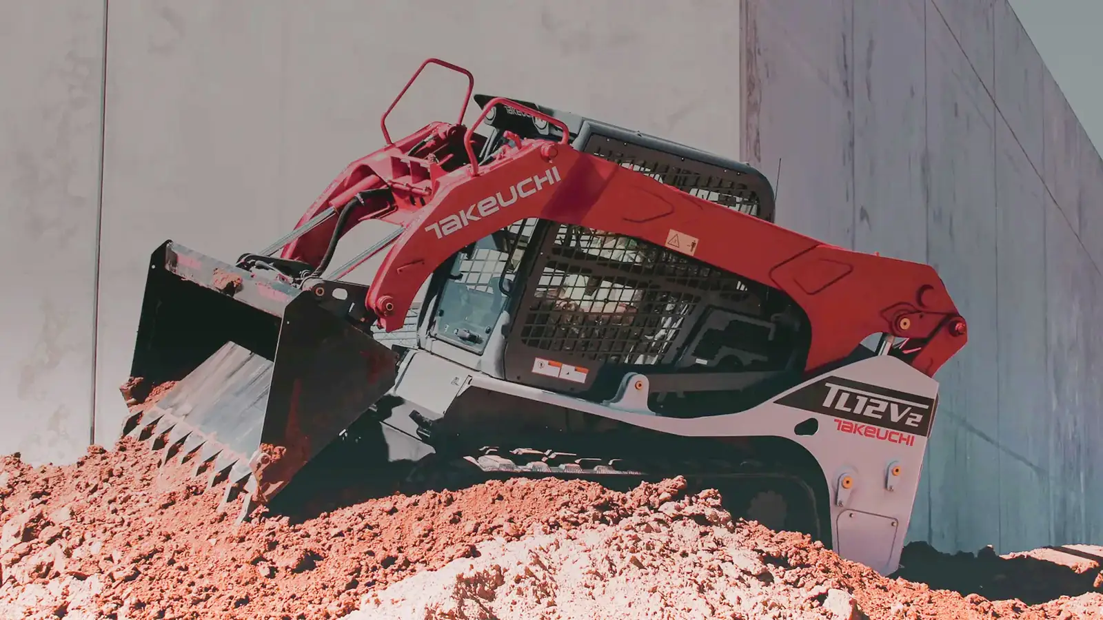 Takeuchi TL12V2 track loader moving material on a graded site
